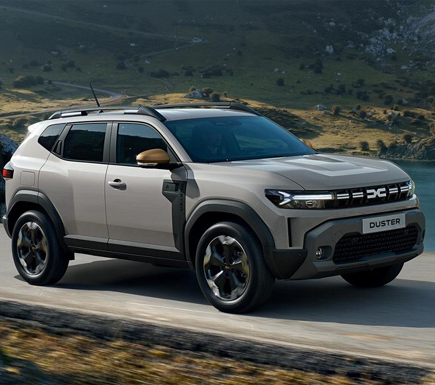 a grey dacia duster passing by a lake