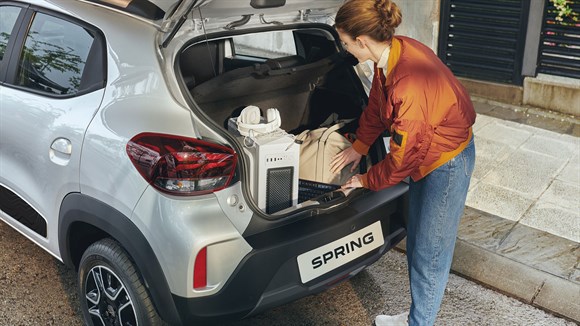 a woman putting bags in the trunk