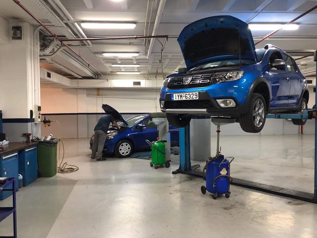 a blue car lifted to be fixed