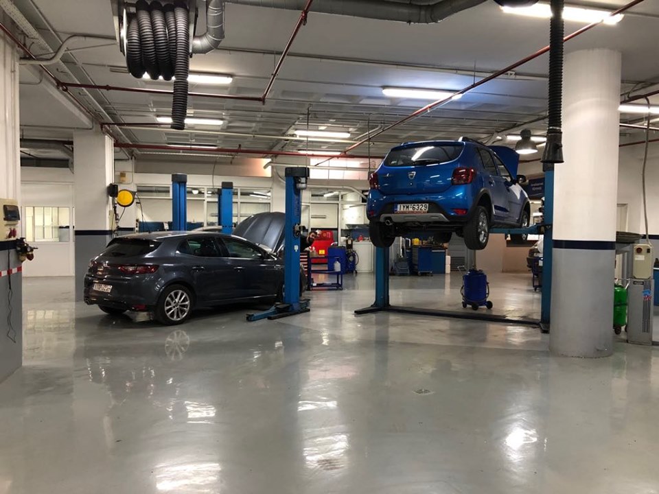 a blue car lifted to be fixed