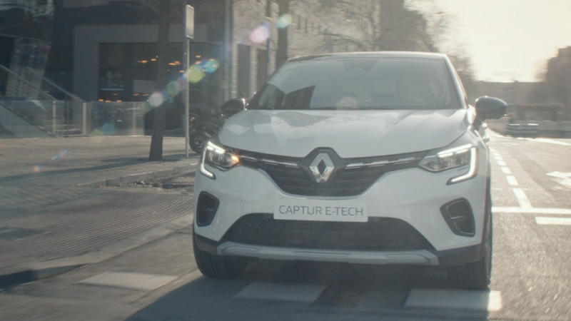 a white captur on the road driving