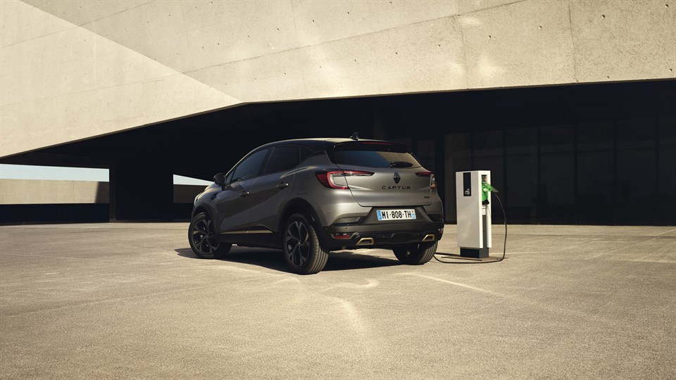 a silver Renault captur is charging