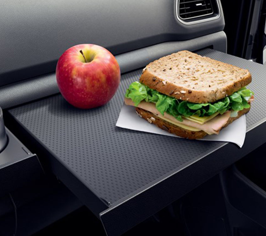 an apple and a sandwich on the inside table of renault new master